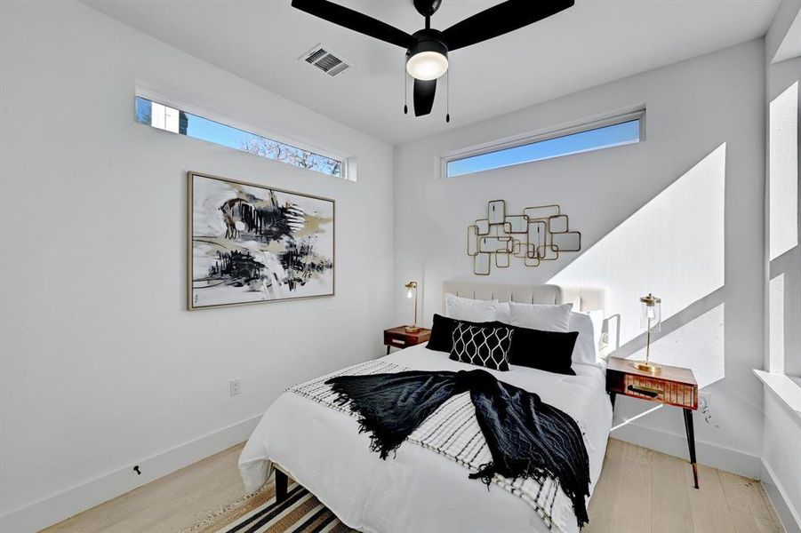 Bedroom featuring wood finished floors, baseboards, and a ceiling fan