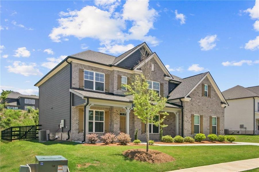 Front exterior of a new home in Carmichael Farms, Canton, GA, highlighting curb appeal (Image 2). Front exterior of a new home in Carmichael Farms, Canton, GA, highlighting curb appeal (Image 2).