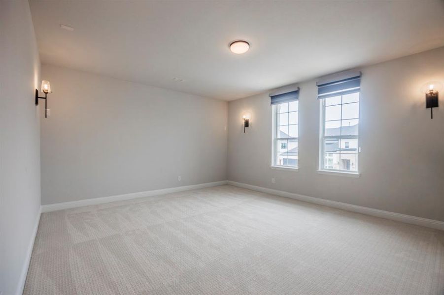 Unfurnished room featuring baseboards and light carpet