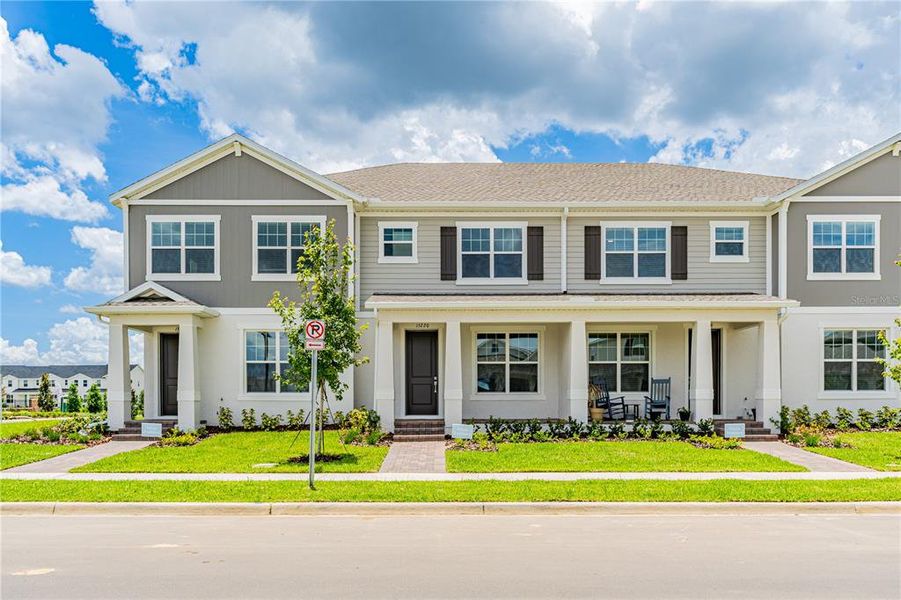 Front exterior of a new home in Osprey Ranch Townhomes, Winter Garden, FL, highlighting curb appeal (Image 20).