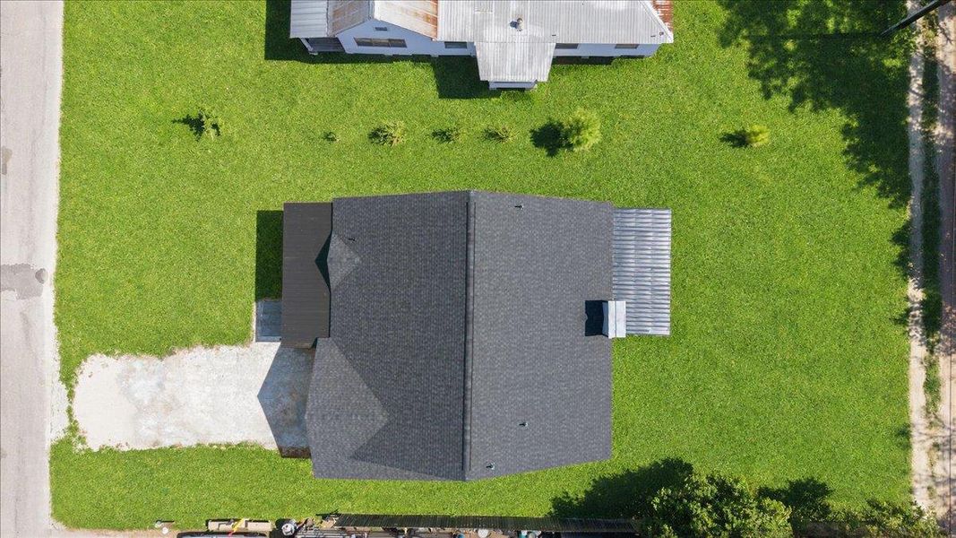 An aerial perspective showcases a neat shingle roof. An aerial perspective showcases a neat shingle roof.