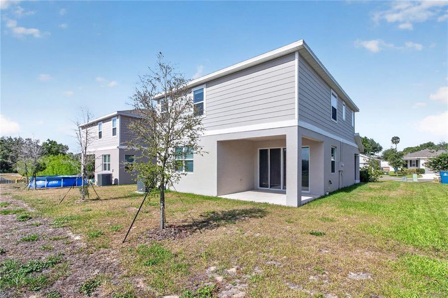 Exterior details and patio area of a home in Seasons at Forest Creek, Haines City (Image 41).