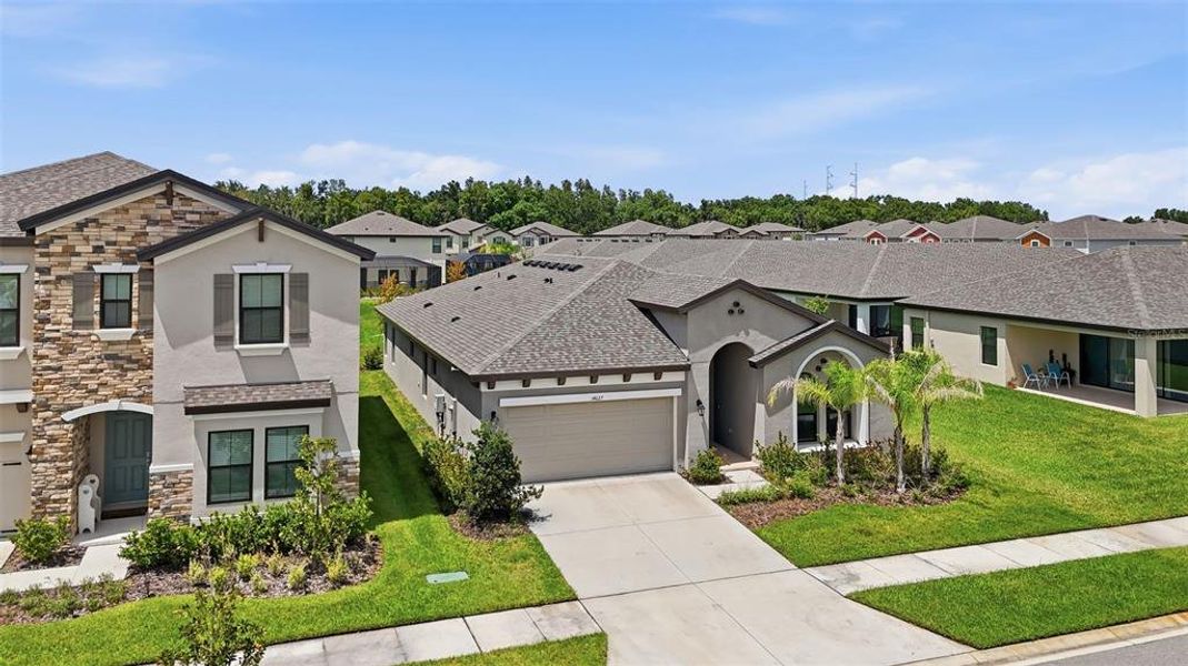 Front exterior of a new home in Hawkstone, Lithia, FL, highlighting curb appeal (Image 22).
