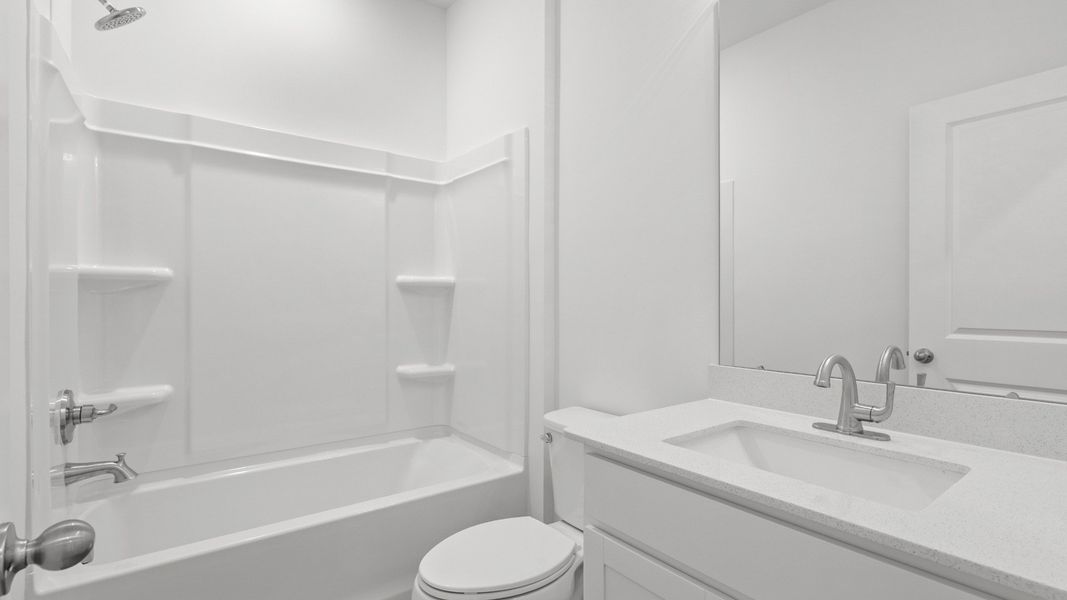 Full secondary bath with tub-shower combo and modern white finishes. Full secondary bath with tub-shower combo and modern white finishes.