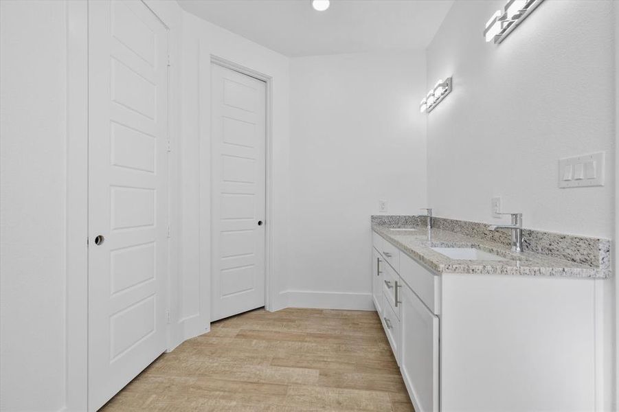 Bathroom featuring vanity and wood-type flooring