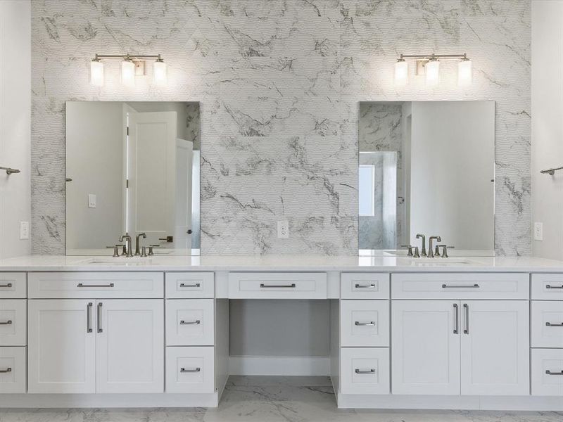 Full bath with double vanity and light marble finish floors