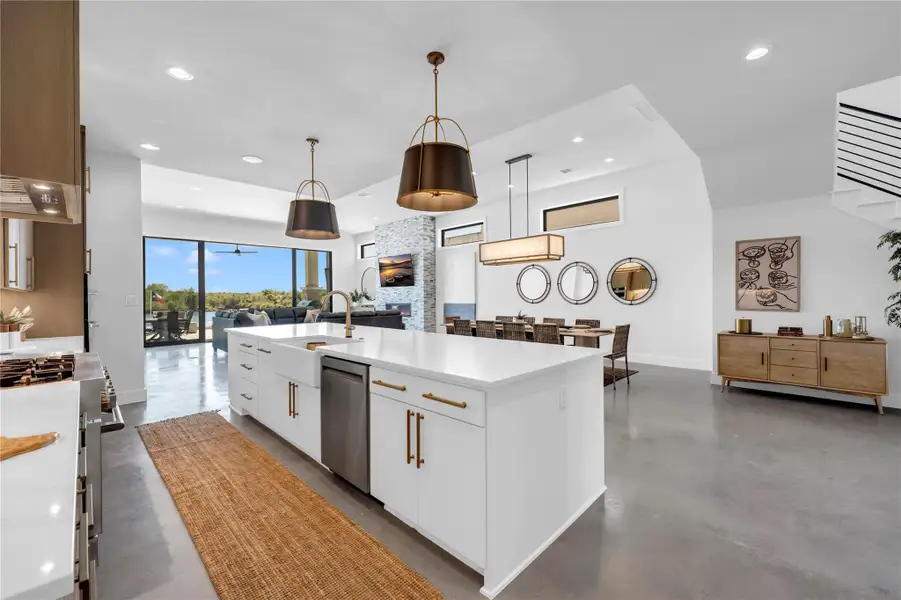 Gleaming concrete floors complement an expansive open layout flowing into the dining area.