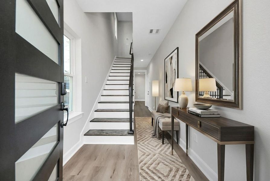 The entryway leads you up the stairs to the main living area or down to the 1st floor guest room.