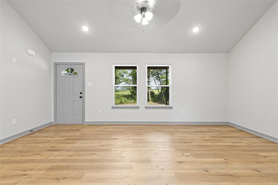 Entrance foyer with light wood-style floors, ceiling fan, recessed lighting, and vaulted ceiling Entrance foyer with light wood-style floors, ceiling fan, recessed lighting, and vaulted ceiling