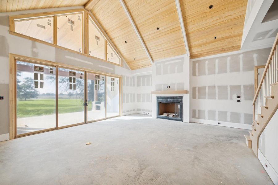 Family room with vaulted ceiling and fireplace.