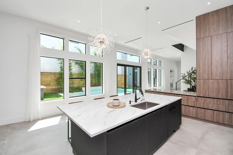 Kitchen overlooks like the side yard pool with sliding doors to welcome the natural light.