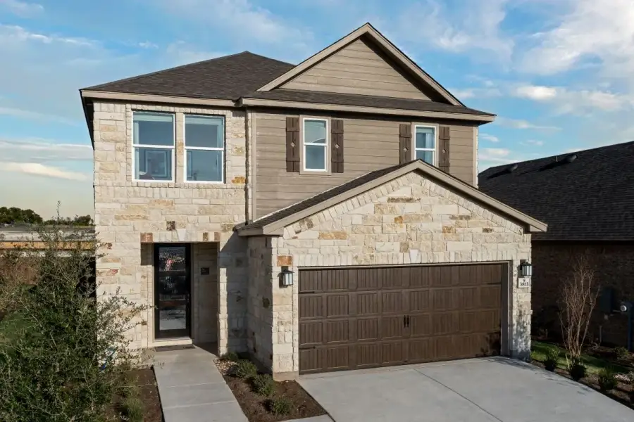 Front exterior of a new home in Salerno - Heritage Collection, Round Rock, TX, highlighting curb appeal (Image 1). Front exterior of a new home in Salerno - Heritage Collection, Round Rock, TX, highlighting curb appeal (Image 1).
