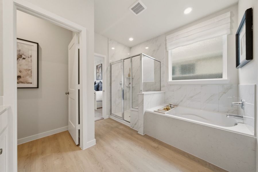 A bathroom with a tub and a sink. A bathroom with a tub and a sink.