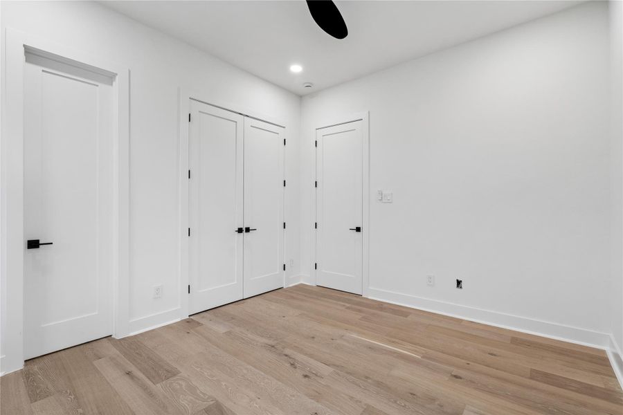 An intentional pause within the home—this first-floor bedroom pairs tailored finishes with a serene, minimalist backdrop. Ideal for guests or multigenerational living, it feels both private and quietly connected.