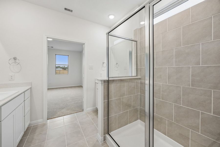 Primary Bathroom in the Magnolia home plan by Trophy Signature Homes – REPRESENTATIVE PHOTO