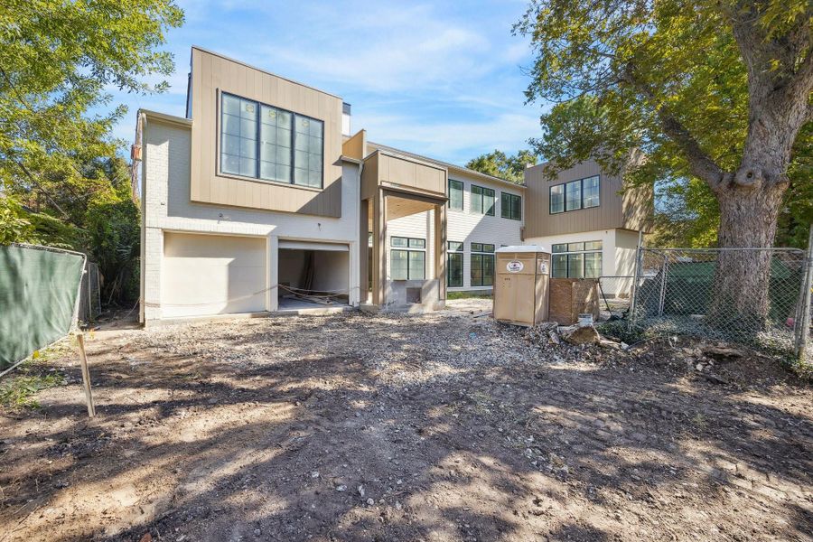 The home is located on the corner with a side loading two car garage.