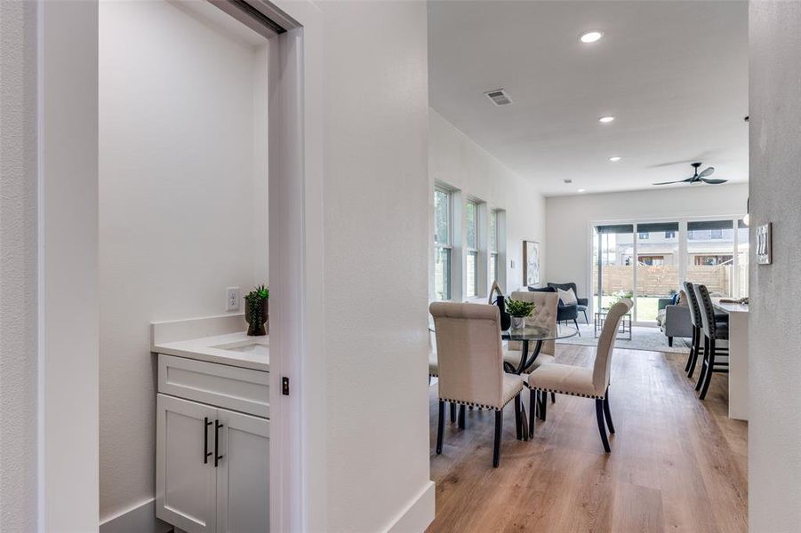 Dining room with a ceiling fan, light wood-type flooring, and recessed lighting Dining room with a ceiling fan, light wood-type flooring, and recessed lighting