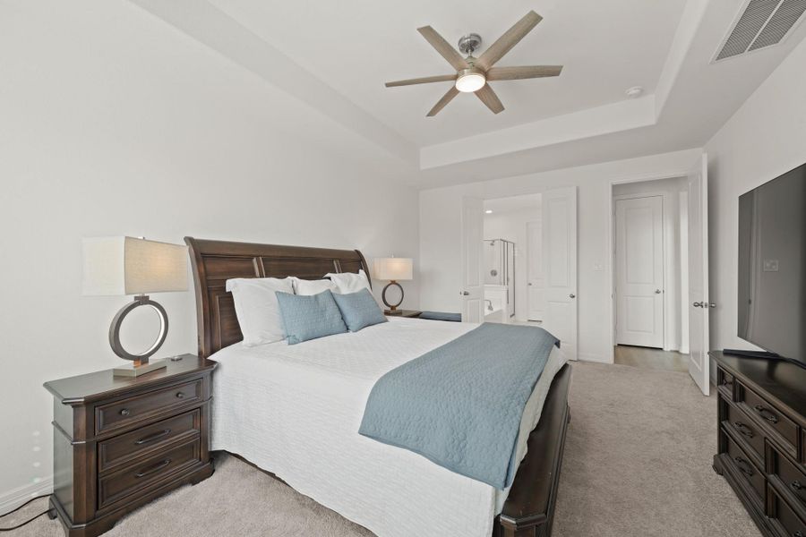 Tray ceilings add a featured design element to the primary retreat.