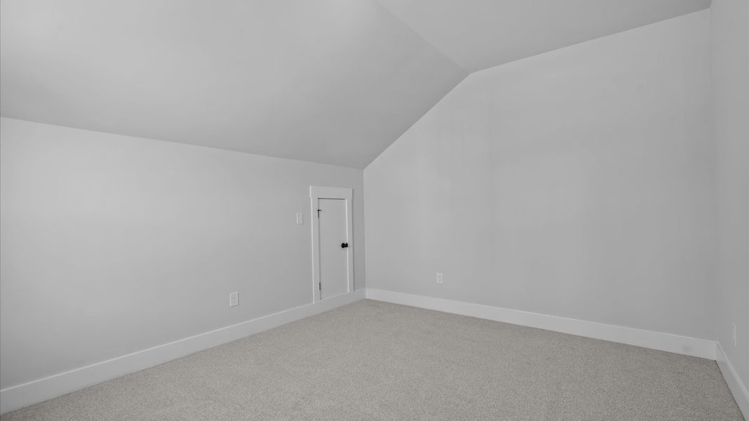 Superior comfort in a secondary bedroom with plush carpet and an oversized walk-in closet