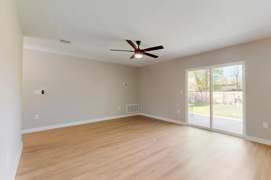 New oak like flooring  and cute ceiling fan. Black fixtures and knobs complete the look. Vertical blinds for the sliding glass door have been ordered.