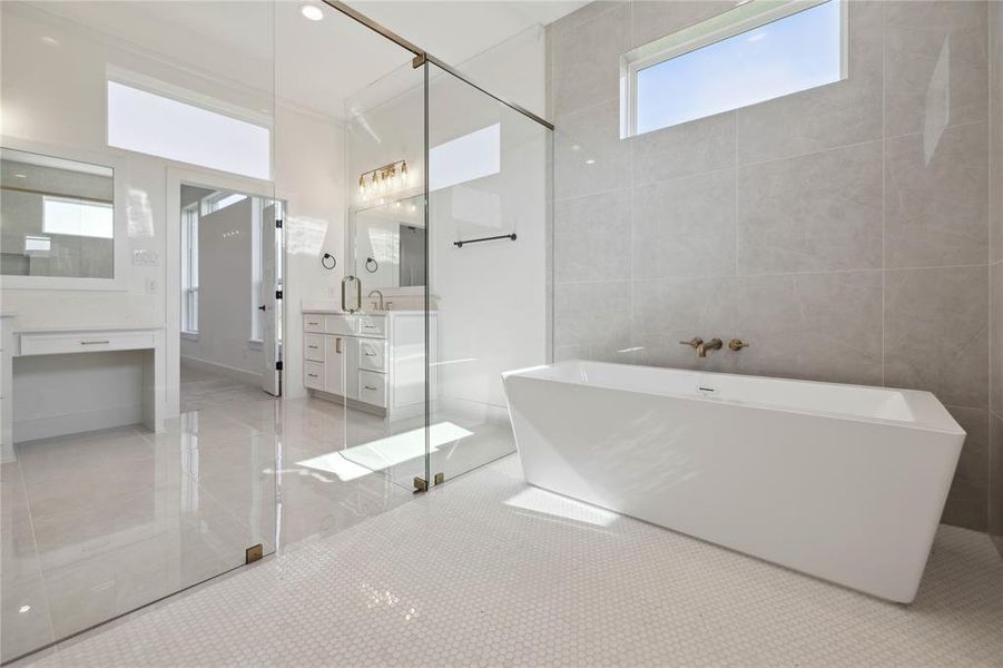 Bathroom with tile walls, vanity, plus walk in shower, and tile patterned flooring