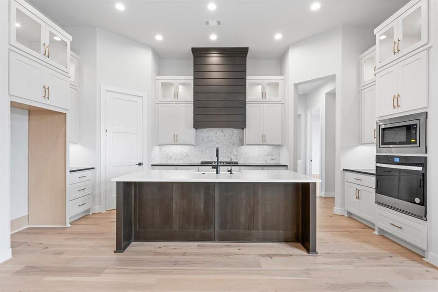 Kitchen with Stacked Cabinets, Cabinet Hardware, and Under Cabinet Lighting