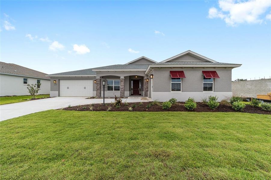 Front exterior of a new home in On Top of the World Communities, Ocala, FL, highlighting curb appeal (Image 2).