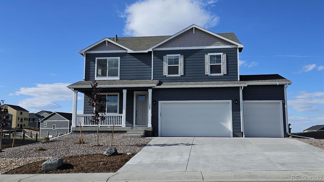 Front exterior of a new home in Spring Valley Ranch, Elizabeth, CO, highlighting curb appeal (Image 1).