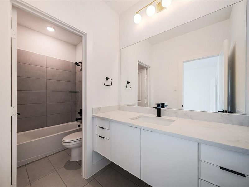 Full bathroom with vanity, light tile patterned floors, shower / bathtub combination, and recessed lighting