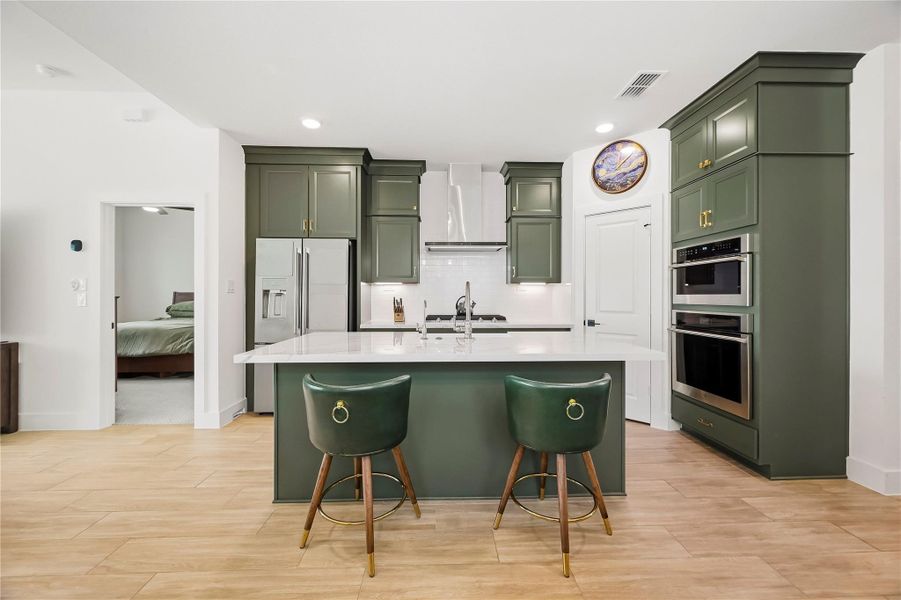 The impressive kitchen island pairs beauty with everyday function, featuring a generous breakfast bar, built-in apron sink and reverse osmosis system, creating an inviting centerpiece for morning coffee, casual dining and conversation while meals come together. The impressive kitchen island pairs beauty with everyday function, featuring a generous breakfast bar, built-in apron sink and reverse osmosis system, creating an inviting centerpiece for morning coffee, casual dining and conversation while meals come together.