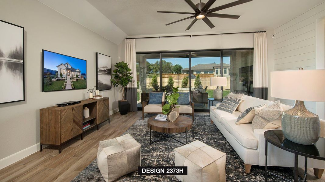 Living room featuring wood finished floors and a ceiling fan Living room featuring wood finished floors and a ceiling fan