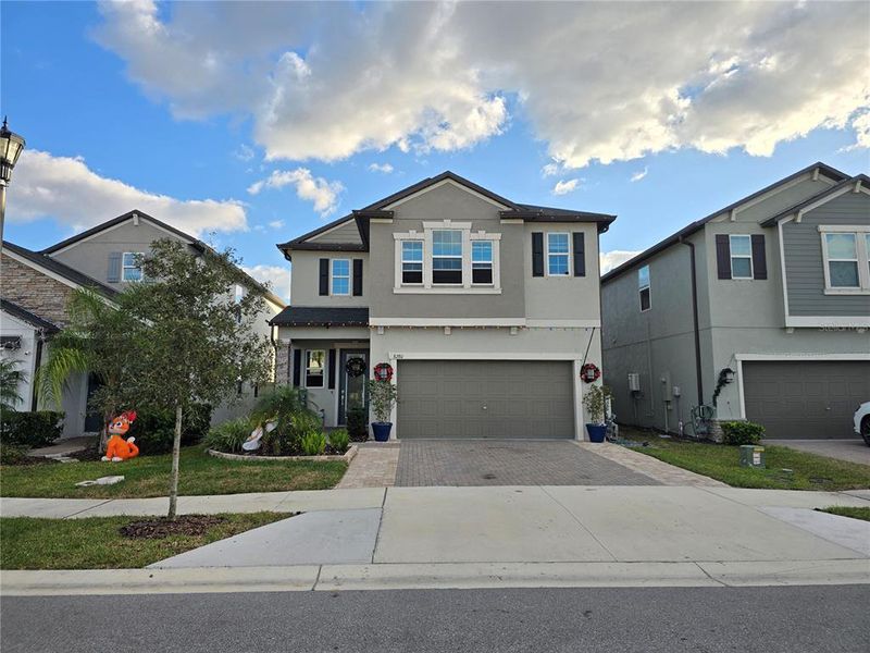 Front exterior of a new home in Bryant Square: The Manors, New Port Richey, FL, highlighting curb appeal (Image 24).