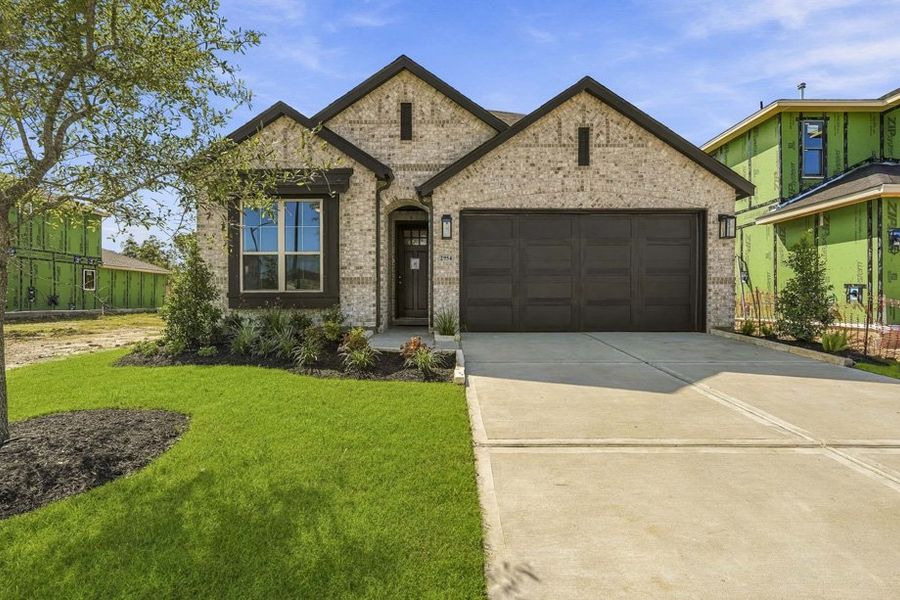 Front exterior of a new home in Midline, Webster, TX, highlighting curb appeal (Image 1). Front exterior of a new home in Midline, Webster, TX, highlighting curb appeal (Image 1).