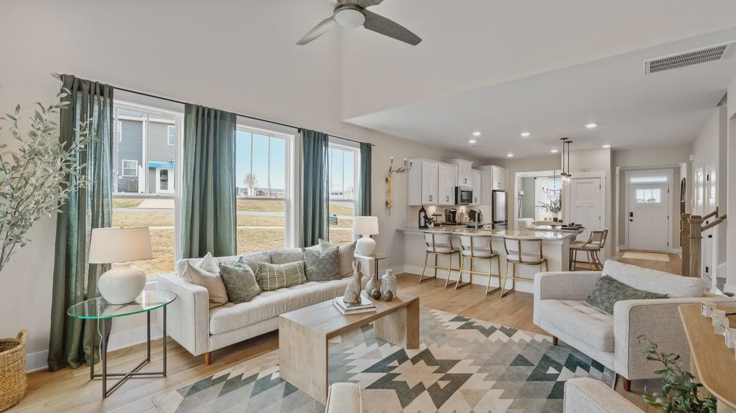 First-class living space featuring expansive ceilings, elegant design, and open sightlines to the kitchen at Barton Hollow