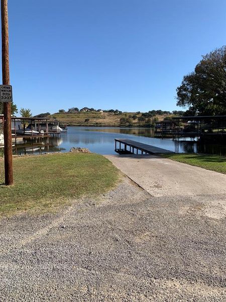 Dock area with a yard and a water view