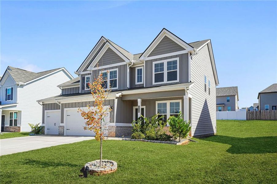 Front exterior of a new home in Berkeley Lakes, Locust Grove, GA, highlighting curb appeal (Image 2).