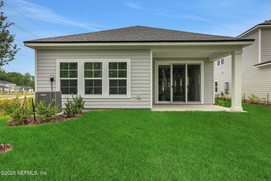 Front exterior of a new home in TrailMark, St. Augustine, FL, highlighting curb appeal (Image 22). Front exterior of a new home in TrailMark, St. Augustine, FL, highlighting curb appeal (Image 22).