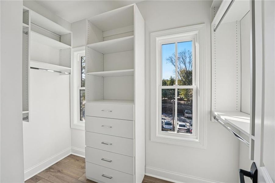 Primary bedoom customized closet with organizer- since this is an End Unit- you have 2 windows that bring in natural light .  Image is of previously built Chamberlain.