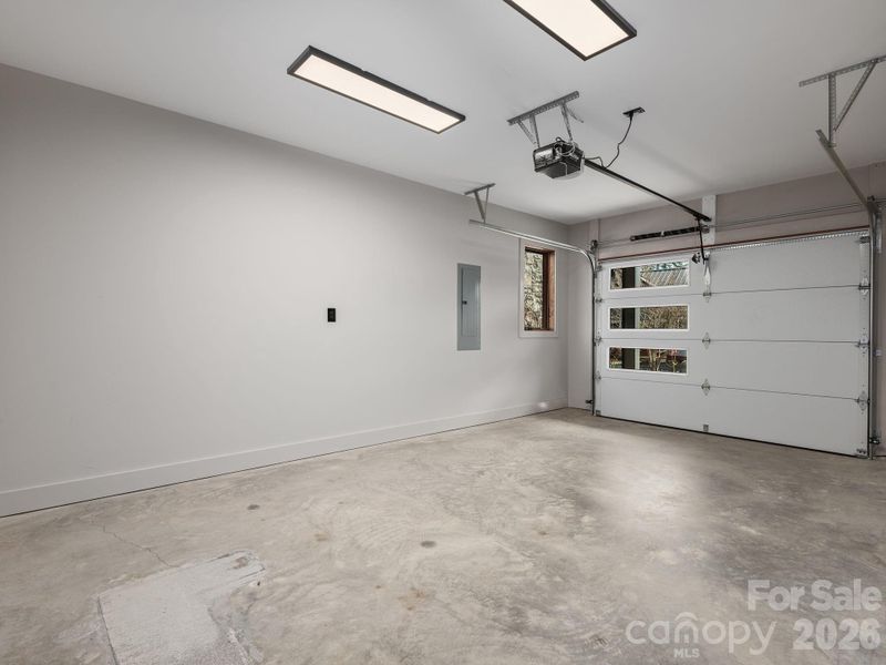 Representative photo from 50 Verde Drive showing the builder’s quality of construction and finish level, including an attached one-car garage with overhead steel sectional garage door and automatic opener.
