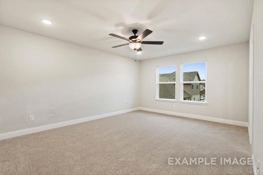 Carpeted empty room with ceiling fan