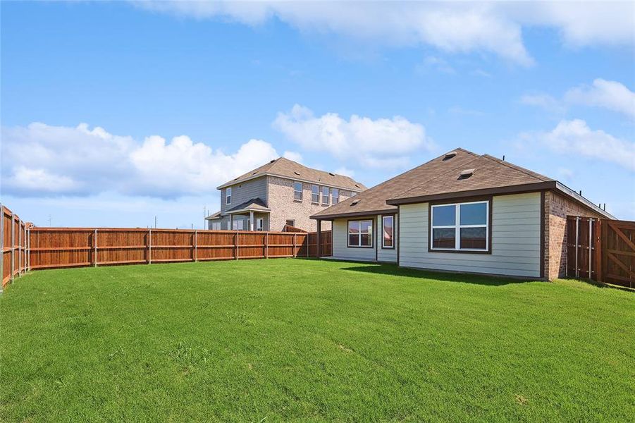 Rear view of house with a yard