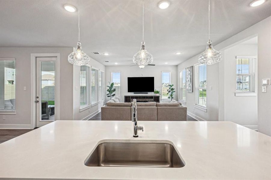 Kitchen featuring pendant lighting, a center island with single basin sink