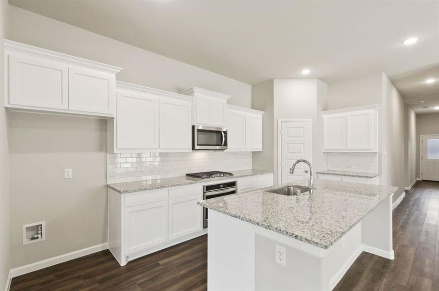 Kitchen in the Quartz home plan by Trophy Signature Homes – REPRESENTATIVE PHOTO