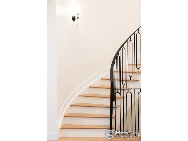Stunning curved staircase was custom crafted by local artisans