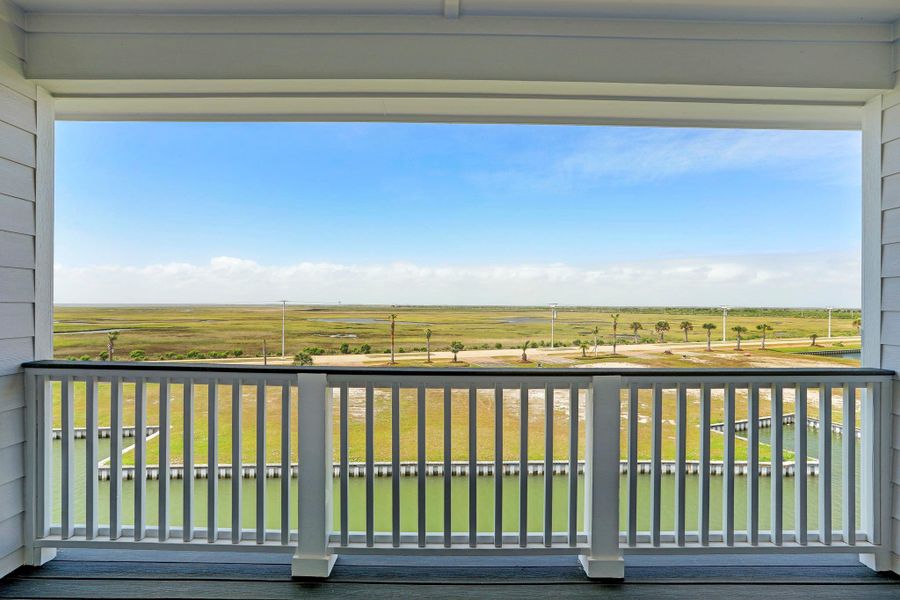 Gameroom balcony offers plenty of room for outdoor lounging and taking in beautiful sunsets over the wetlands. Gameroom balcony offers plenty of room for outdoor lounging and taking in beautiful sunsets over the wetlands.