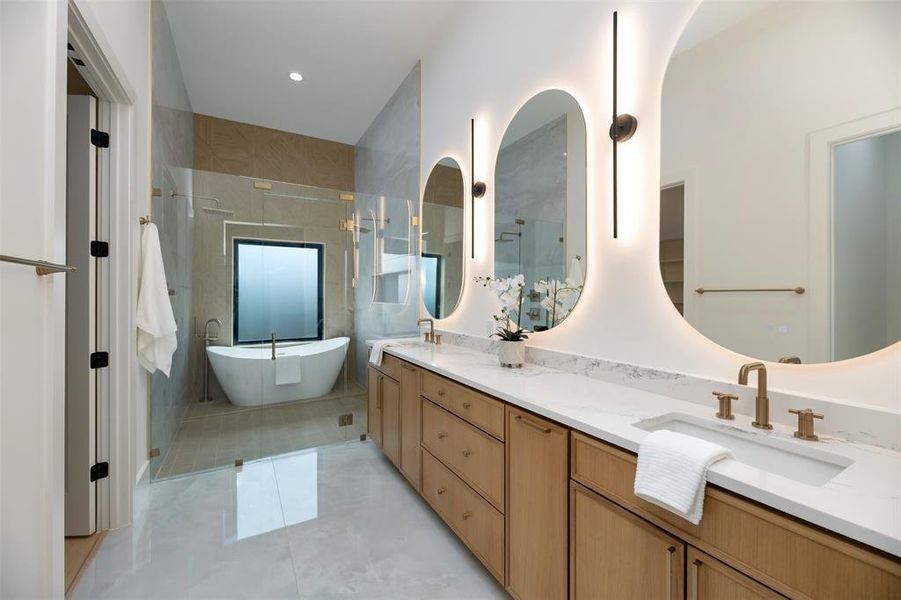 Bathroom with a freestanding bath, double vanity, a shower with shower door, light tile patterned flooring, and tile walls Bathroom with a freestanding bath, double vanity, a shower with shower door, light tile patterned flooring, and tile walls