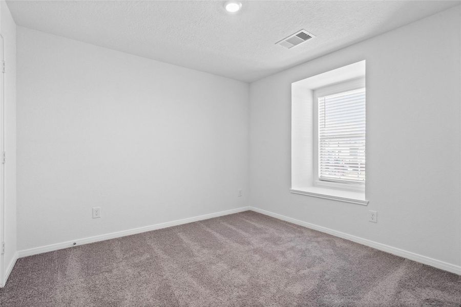 This secondary bedroom offers comfort and style with plush carpeting, neutral paint tones, recessed lighting, generously sized closet, and a large recessed window that creates depth and character to this room. This secondary bedroom offers comfort and style with plush carpeting, neutral paint tones, recessed lighting, generously sized closet, and a large recessed window that creates depth and character to this room.