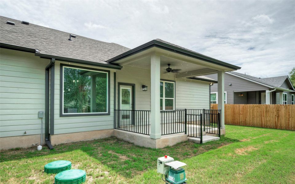Back of property with ceiling fan and roof with shingles Back of property with ceiling fan and roof with shingles