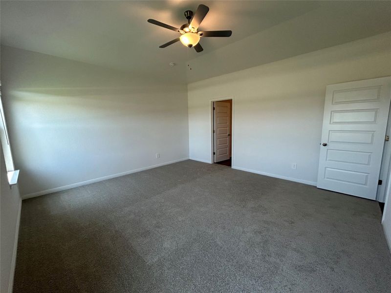Unfurnished bedroom with carpet and a ceiling fan