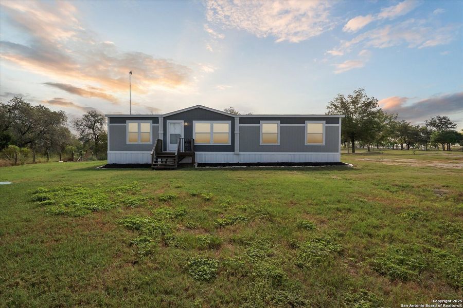Front exterior of a new home in , Somerset, TX, highlighting curb appeal (Image 22). Front exterior of a new home in , Somerset, TX, highlighting curb appeal (Image 22).